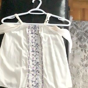 White top with vines of flowers